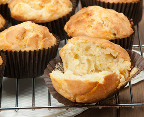 Homemade Cheddar Muffins In Paper Cases. Wooden Table.