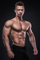 Fototapeta na wymiar Young bodybuilder showing his muscles