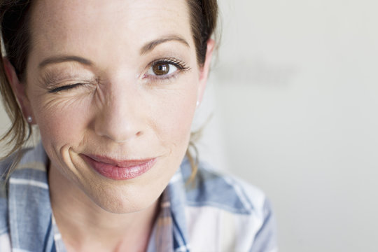 Portrait of brown eye mature woman looking at camera winking