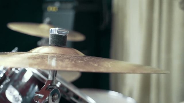 Musician playing drums at studio, close up, slow motion