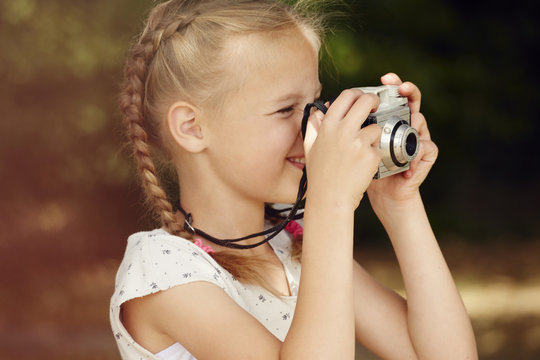 Head And Shoulder Side View Of Girl Using Film Camera