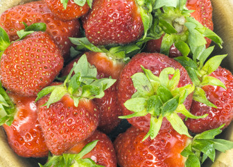 fresh whole strawberries in wooden bowl