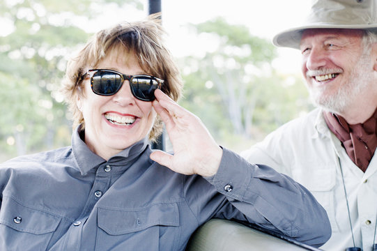Senior man and wife on four wheel drive safari, Kafue National Park, Zambia