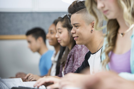 Row of teenage high school students in computer class