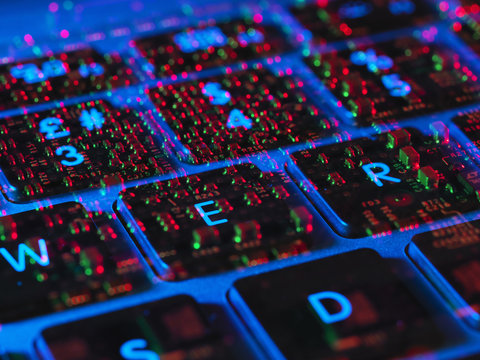 Double exposure of the inside and out of a laptop computer showing the electronic components under the keyboard