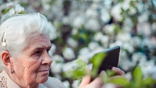 Senior woman using tablet to take photos
