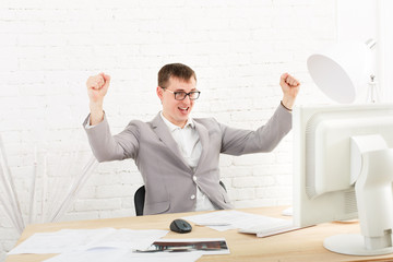 Young businessman in office with computer