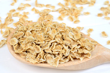 Spoon with oats on wooden table