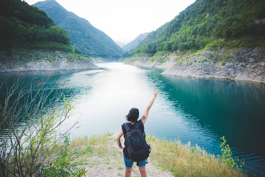 Tourist Raising Arm At Lake Garda, Italy