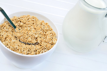 Oat flakes in a white bowl with milk