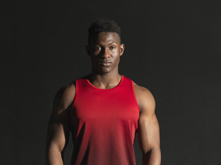 Portrait of athlete, black background