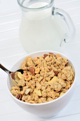 Delicious muesli in white bowl and milk