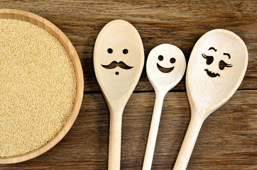 Family wooden spoon with amaranth seeds in a bamboo bowl