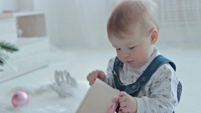 little boy opening a little gift
