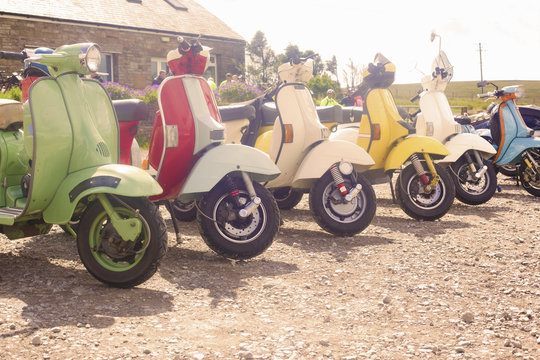 Colourful scooters parked in a row