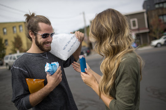 Young couple carrying provisions for road trip