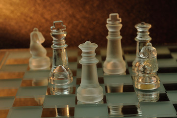Chess pieces displayed on a glass chess board