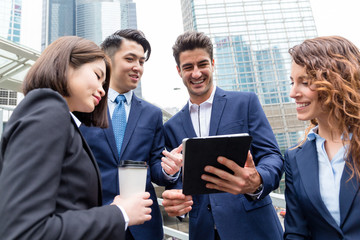 business partners discussing ideas and planning work on tablet