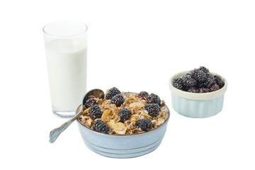breakfast of cereal and blackberry fruits with glass of milk