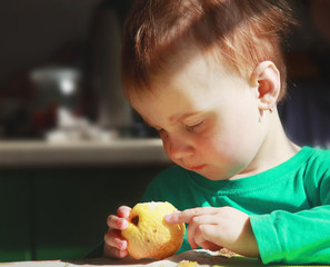 beautiful baby girl eats an apple (bio food, health, healthy lif
