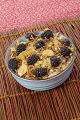 bowl full of blackberry fruit and cornflakes