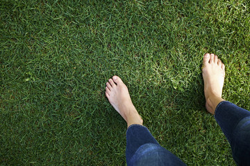 Woman standing on grass, low section, elevated view