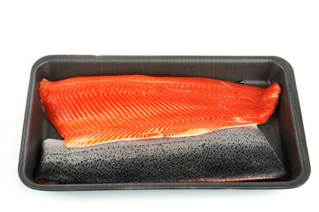 fresh salmon fillet in black container tray