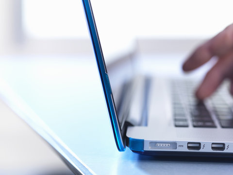 Person using laptop, close up