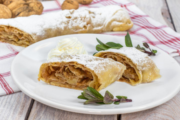 Two Slices Homemade Apple Strudel on a Plate with Whipped Cream