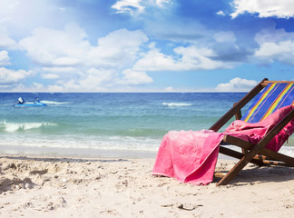 Fototapeta na wymiar Towel on beach chairs at beautiful tropical beach