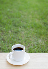 Hot black coffee on wood floor
