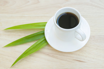 Hot black coffee on wood floor