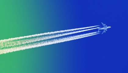 Plane in blue sky - Bright blue and green sky