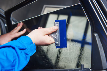 car tinting. Automobile mechanic technician applying foil 