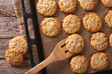 Anzac biscuits close up on a baking sheet. horizontal view from above
