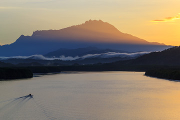 Majestic sunrise over the kinabalu mountain , Beautiful sunrise at Mengkabong river, The magnificent Mount Kinabalu early morning.