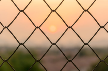 Fototapeta premium steel grate with sunset sky background