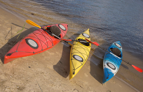 Camping with kayaks on the beach on a sunny day.