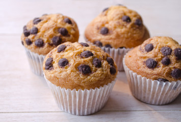 Confectionery product tasty chocolate muffins on wooden background. Delicious cupcake cookies