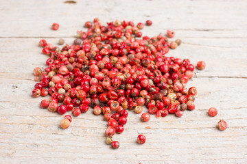 Peppercorns close up on wood