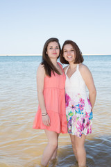 Two young girls playful in the water at the beach