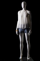 Fototapeta na wymiar White top, shorts and accessories. Female mannequin wearing casual outfit. Stylish clothing for young ladies. Attractive prices in boutique.