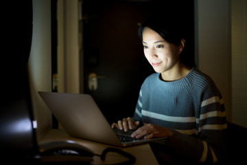 Fototapeta na wymiar Woman working on notebook computer