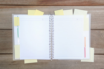 Top view of open notebook with many sticky notes