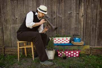 Gardener  Playing on Trumpet to His Flowers