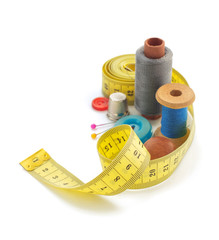 sewing tools and measuring tape on white