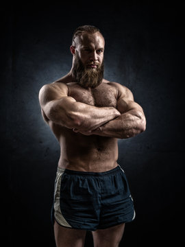 Bodybuilder topless over grunge background.
