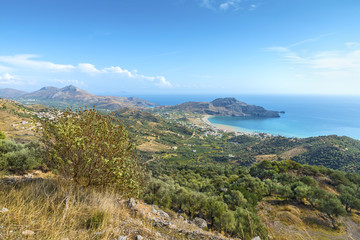 Fototapeta na wymiar Beautiful panoramic view from the height on the Cretan village of Plakias with its picturesque hilly relief, beach and coastline of mediterranean sea.District of Rethymno.Crete island.Greece.Europe.