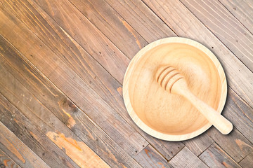 Wooden bowl and dipper on wood texture background