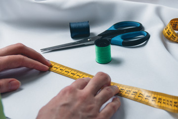 beautiful young woman tailor measuring